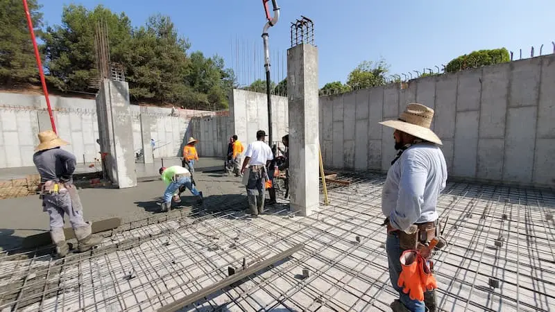 Construction workers pouring concrete